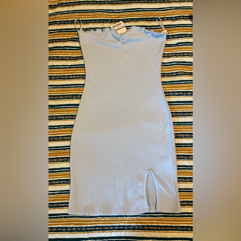 Brand new baby blue mini dress with slit in the bottom front.
